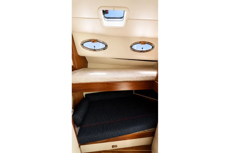 Slide: The Image of Interior cabin of 2005 Compton 33 Downeast Express with bunk beds and portholes. - 16
