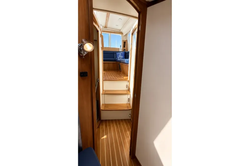 Slide: The Image of Interior view of 2005 Compton 33 Downeast Express boat with wooden flooring and seating area. - 18
