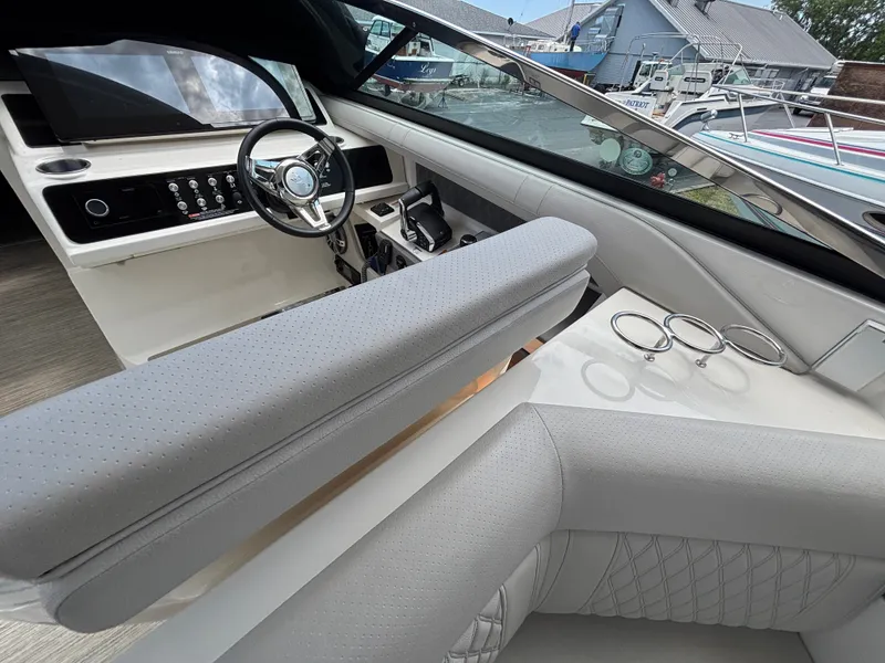 Slide: The Image of The 2024 Sea Ray SLX 310 cockpit features a modern steering wheel and sleek dashboard. - 7
