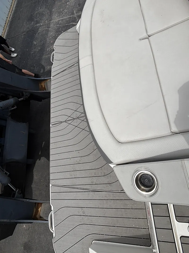 Slide: The Image of The image shows the stern of a Sea Ray SLX 310 boat with gray decking and upholstery. - 3