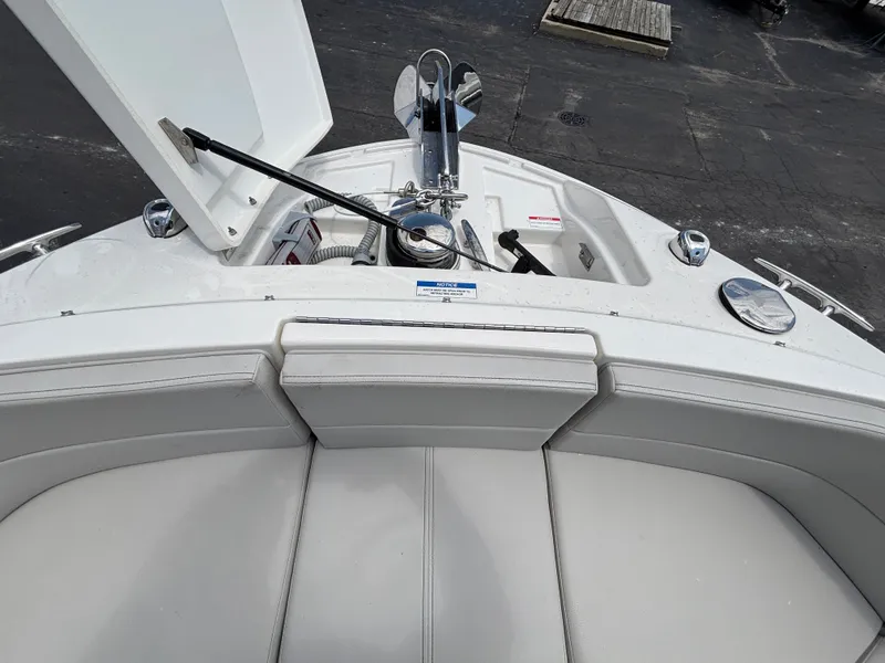 Slide: The Image of The image shows the bow of a 2024 Sea Ray SLX 310 boat with anchor and storage. - 11
