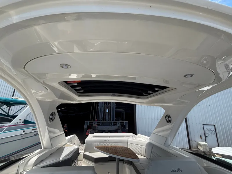 Slide: The Image of The image shows the cockpit of a 2024 Sea Ray SLX 310 with a sleek hardtop. - 13