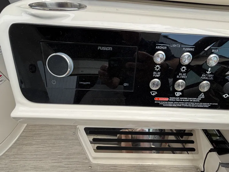 Slide: The Image of The image shows the dashboard of a Sea Ray SLX 310 boat with various controls. - 9