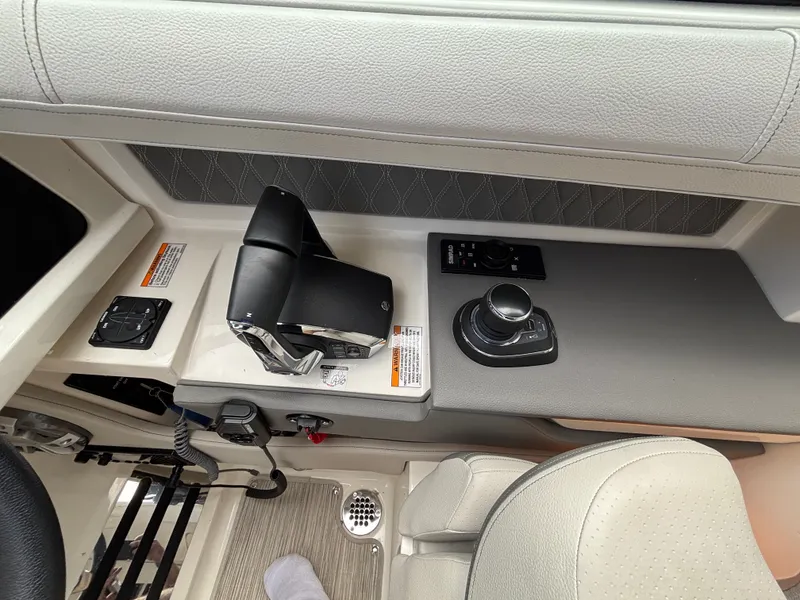 Slide: The Image of The image shows the cockpit of a Sea Ray SLX 310 boat with modern controls and comfortable seating. - 8