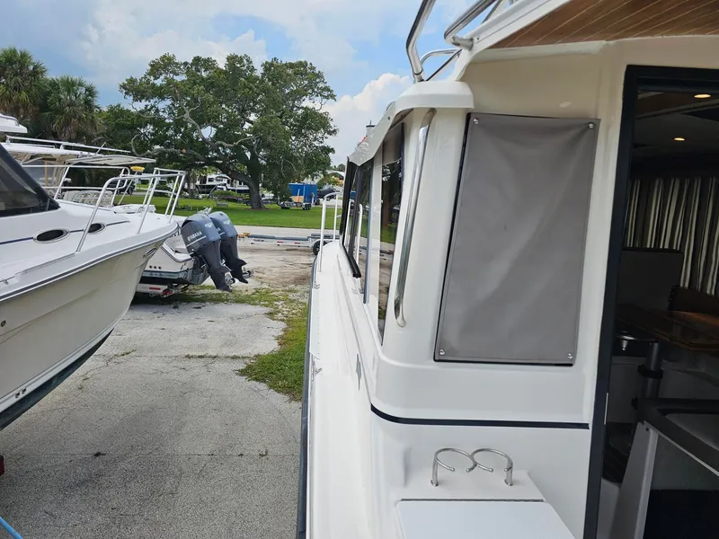 Slide: The Image of A 2021 Cutwater C-28 is parked next to other boats. An outboard motor is visible. - 10