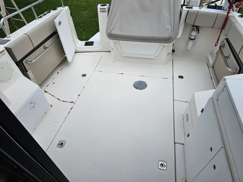 Slide: The Image of The image shows the cockpit of a 2021 Cutwater C-28 boat with a clean, light deck. - 12
