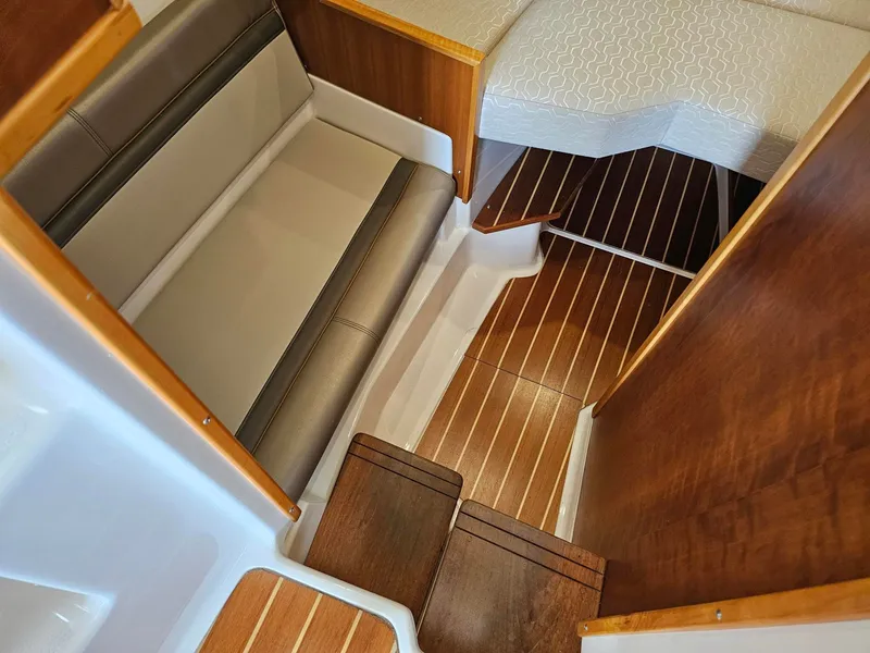 Slide: The Image of Interior of a 2021 Cutwater C-28 with wooden flooring and cushioned seating. - 18