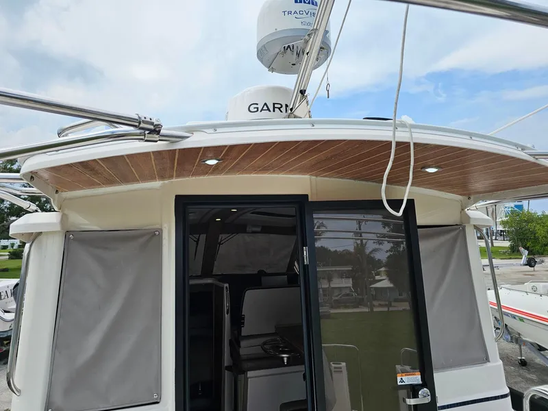 Slide: The Image of The 2021 Cutwater C-28 features a modern cockpit with wood accents and electronic equipment. - 8