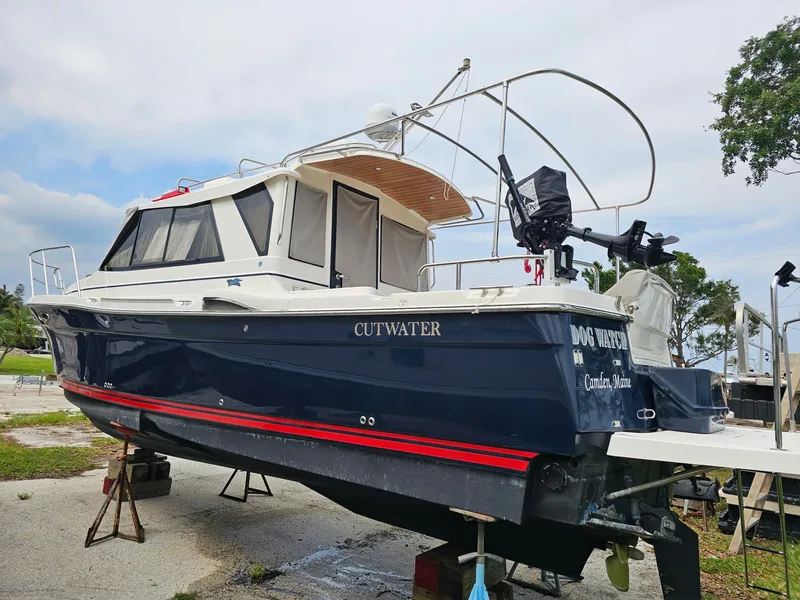 Slide: The Image of A 2021 Cutwater C-28 boat is on a dry dock. It features a blue hull design. - 3