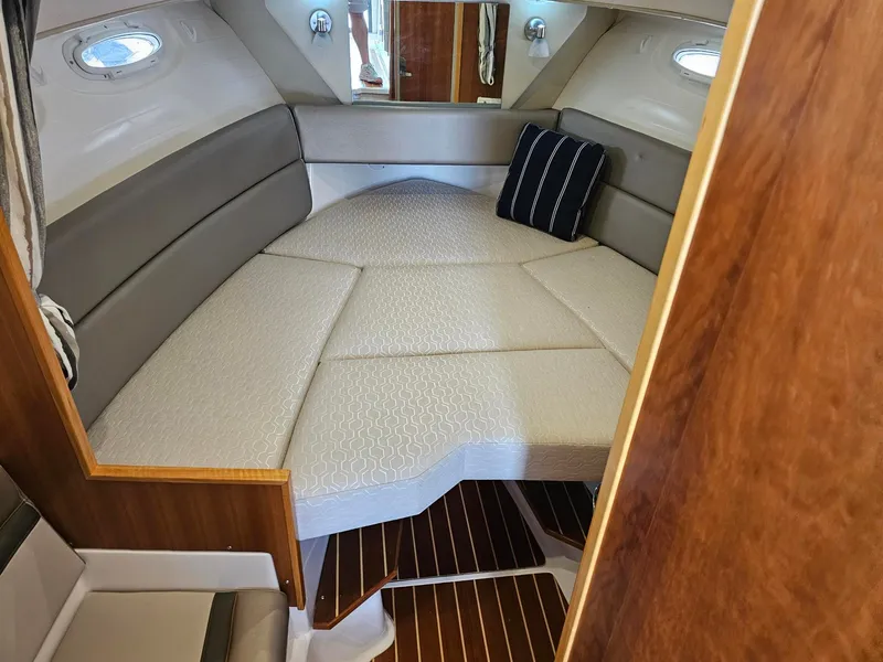 Slide: The Image of Interior of the 2021 Cutwater C-28 featuring a cozy sleeping cabin and wooden flooring. - 5
