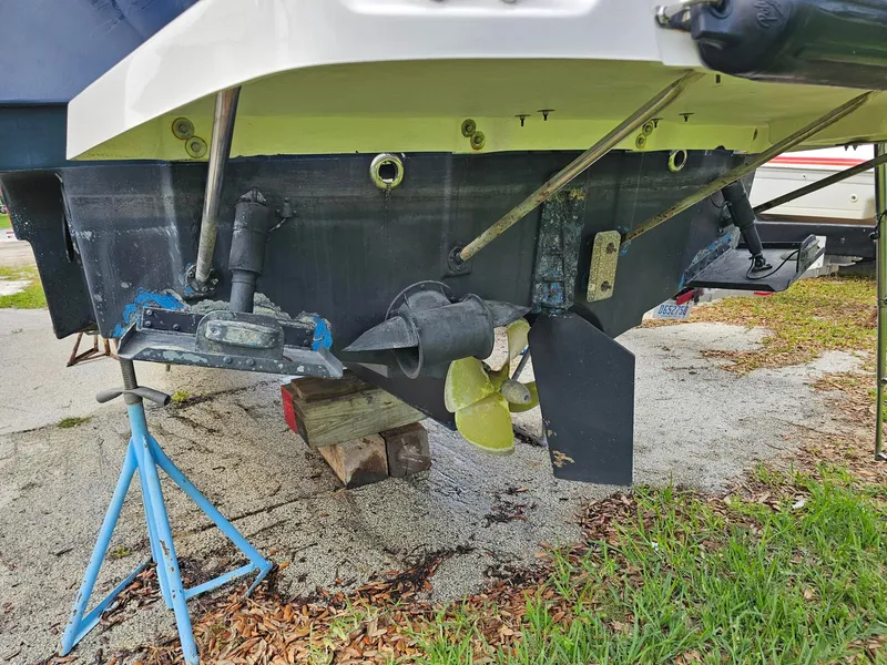 Slide: The Image of The image shows the stern of a 2021 Cutwater C-28 boat, propped up on stands. - 7