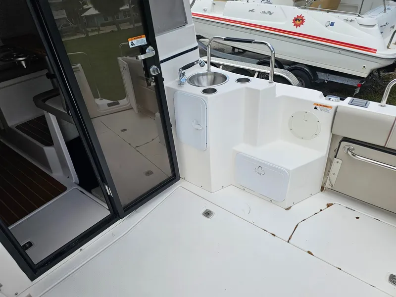 Slide: The Image of The image shows the stern of a 2021 Cutwater C-28 boat with a small sink. - 9