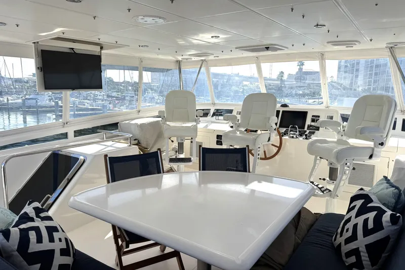 Slide: The Image of Luxurious 2015 Hampton Endurance yacht interior with helm, seating, and marina view. - 70