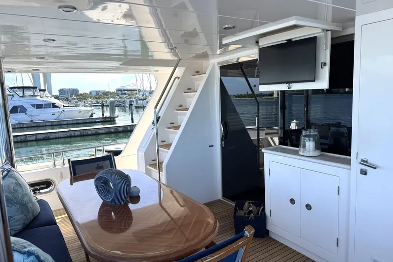 Slide: The Image of Luxurious 2015 Hampton Endurance yacht interior with elegant dining area and marina view. - 87