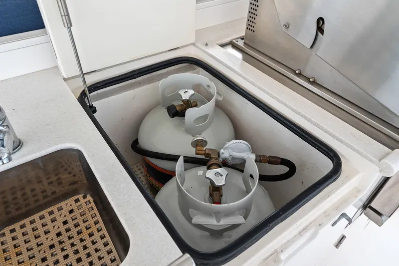 Slide: The Image of Propane tanks in a 2015 Hampton Endurance yacht kitchen compartment. - 73