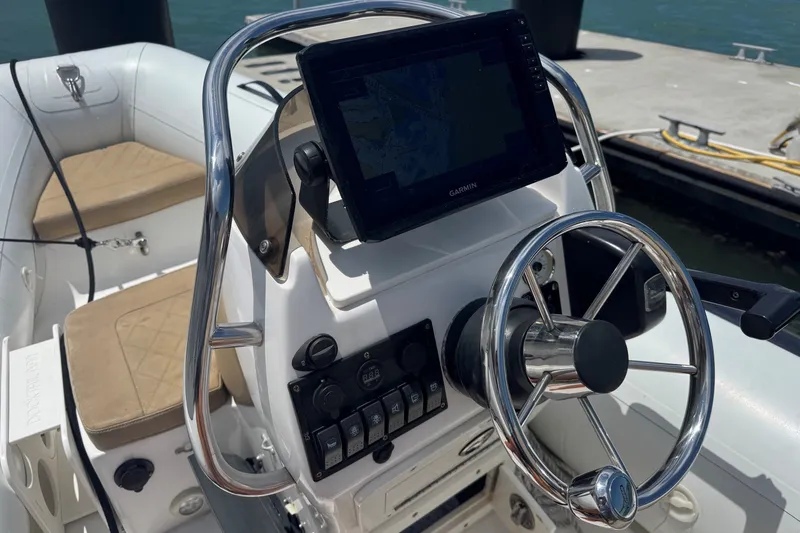 Slide: The Image of Steering console of a 2015 Hampton Endurance boat with Garmin navigation system. - 93