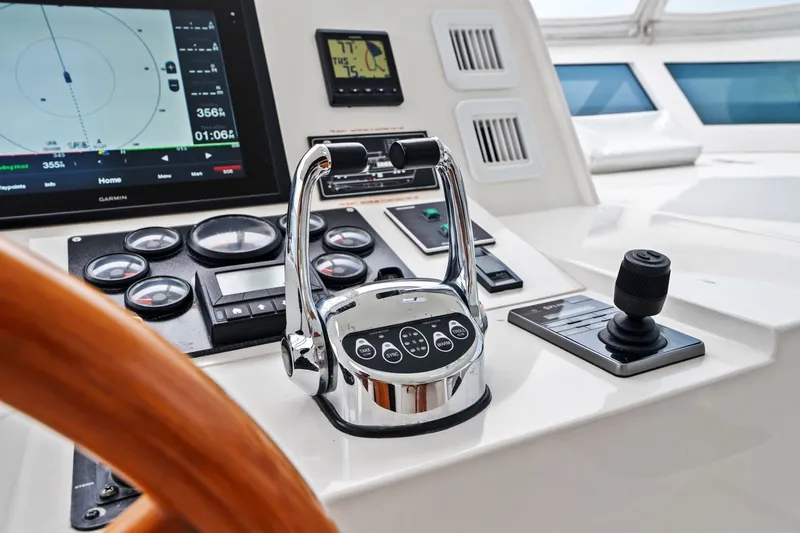 Slide: The Image of Control panel of a 2015 Hampton Endurance yacht with navigation instruments and steering wheel. - 67
