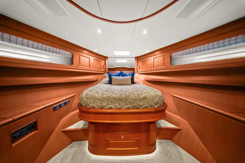 Slide: The Image of Luxurious 2015 Hampton Endurance yacht bedroom with elegant wood finish and cozy bedding. - 41