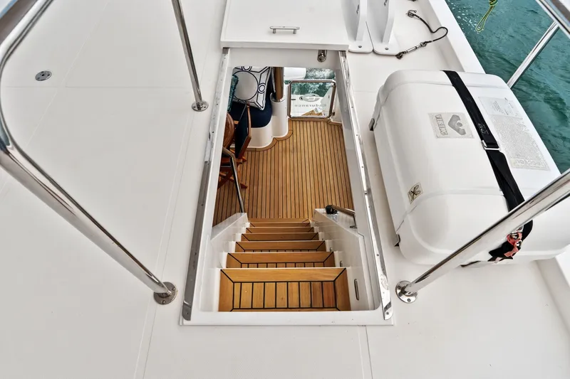 Slide: The Image of Staircase on 2015 Hampton Endurance yacht, leading to lower deck with wooden flooring. - 78
