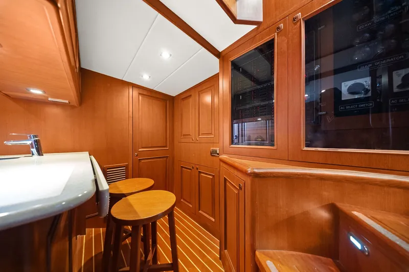 Slide: The Image of Luxurious wooden interior of a 2015 Hampton Endurance yacht with stools and cabinetry. - 49