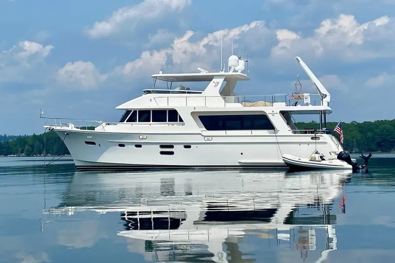 Slide: The Image of 2015 Hampton Endurance yacht on calm water with clear sky reflection. - 4