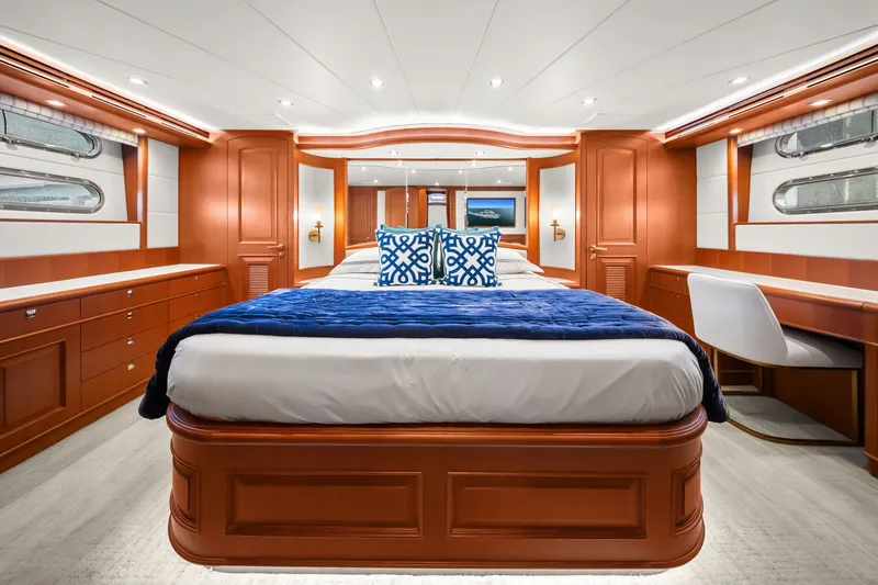Slide: The Image of Luxurious 2015 Hampton Endurance yacht bedroom with elegant wood finishes and plush bedding. - 26