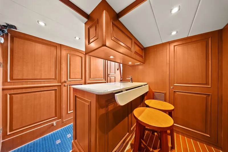 Slide: The Image of Luxurious wooden interior of a 2015 Hampton Endurance yacht with bar and stools. - 48