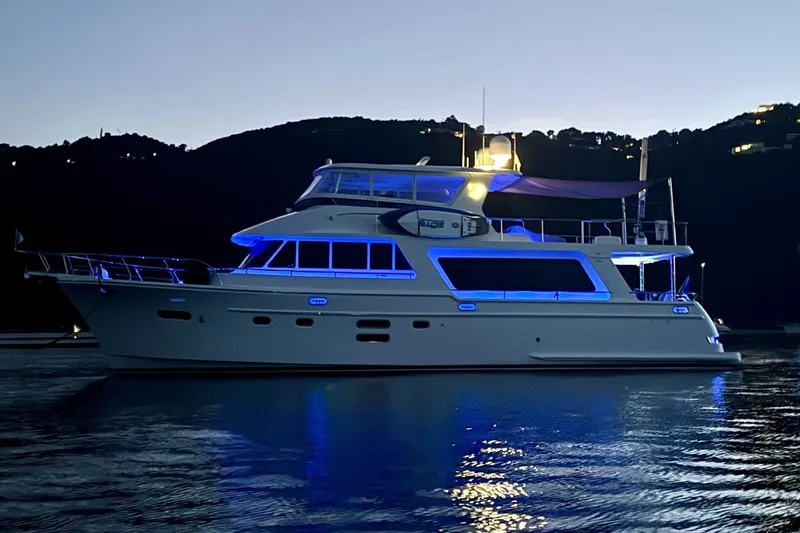 Slide: The Image of Luxurious 2015 Hampton Endurance yacht illuminated at dusk on tranquil waters. - 5
