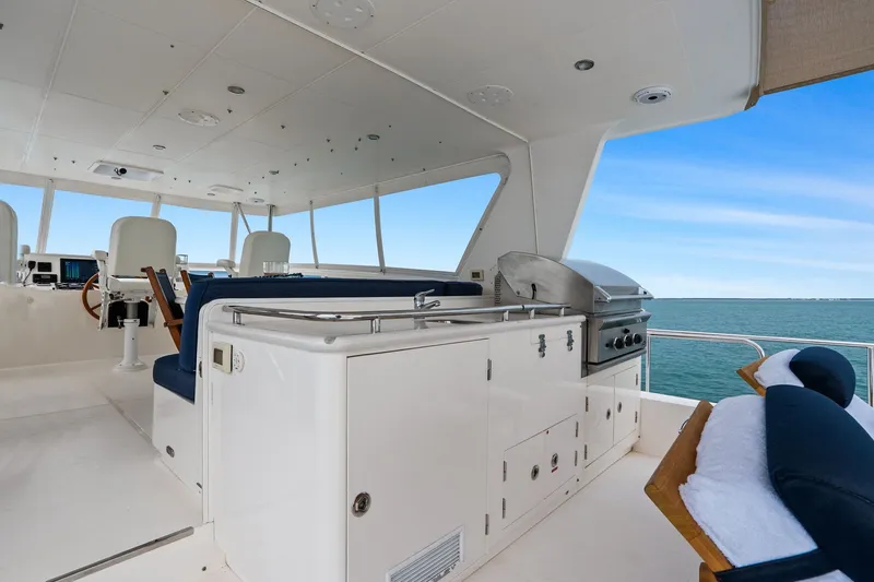 Slide: The Image of Luxurious 2015 Hampton Endurance yacht interior with seating and grill, overlooking the ocean. - 71