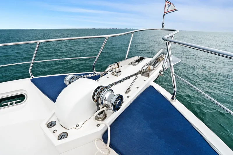 Slide: The Image of Bow of a 2015 Hampton Endurance yacht with anchor chain and ocean view. - 84