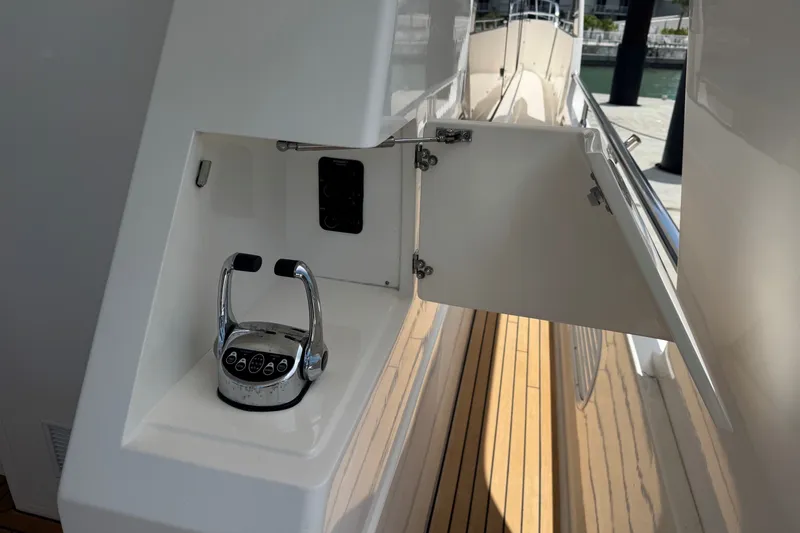 Slide: The Image of 2015 Hampton Endurance yacht control panel with open compartment on teak deck. - 80
