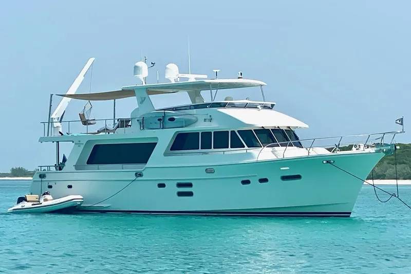 Slide: The Image of Luxury 2015 Hampton Endurance yacht anchored in clear turquoise waters. - 3