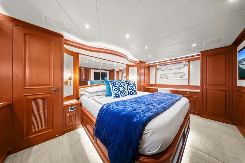 Slide: The Image of Luxurious 2015 Hampton Endurance yacht bedroom with elegant wood paneling and plush bedding. - 27