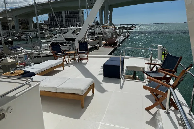 Slide: The Image of Luxury yacht deck with lounge chairs, overlooking marina and water, Hampton Endurance 2015 model. - 76