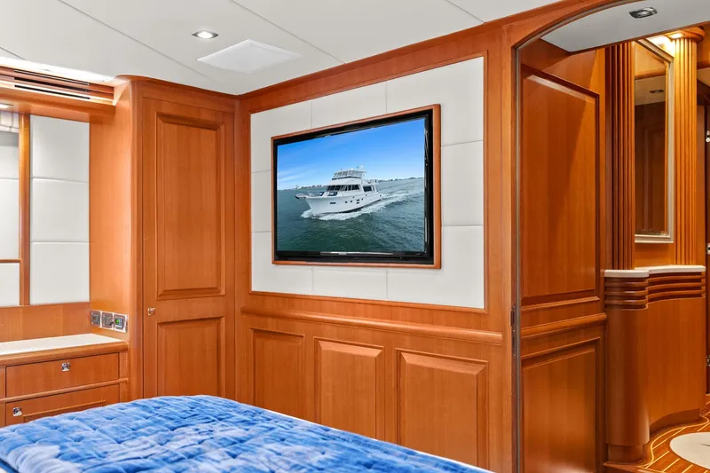 Slide: The Image of Luxurious cabin with wooden walls, a large TV, and a blue bed. - 33
