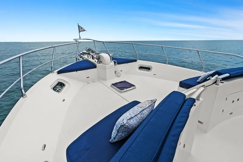 Slide: The Image of Luxurious 2015 Hampton Endurance yacht deck with blue cushions, overlooking serene ocean waters. - 82