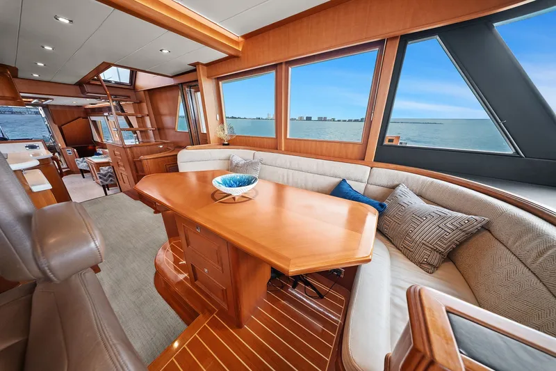 Slide: The Image of Luxurious 2015 Hampton Endurance yacht interior with elegant wood finishes and ocean view. - 17