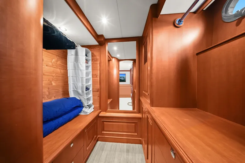 Slide: The Image of Luxurious wooden interior of 2015 Hampton Endurance yacht cabin with storage and bedding. - 32