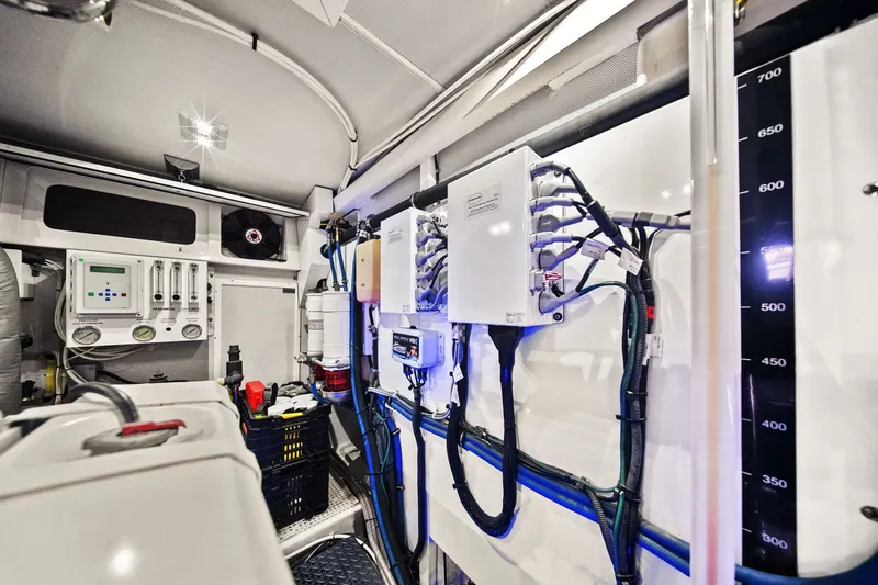 Slide: The Image of Engine room of a 2015 Hampton Endurance yacht with control panels and wiring. - 64