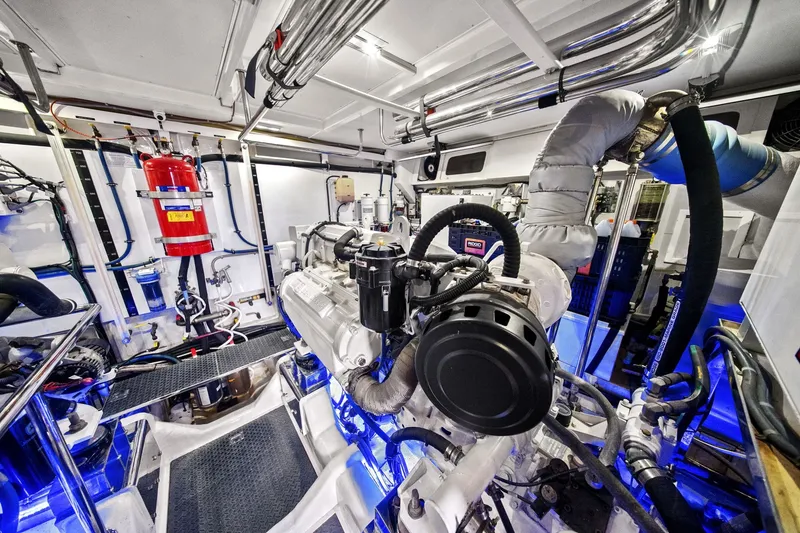Slide: The Image of Engine room of a 2015 Hampton Endurance yacht with advanced machinery and piping. - 62
