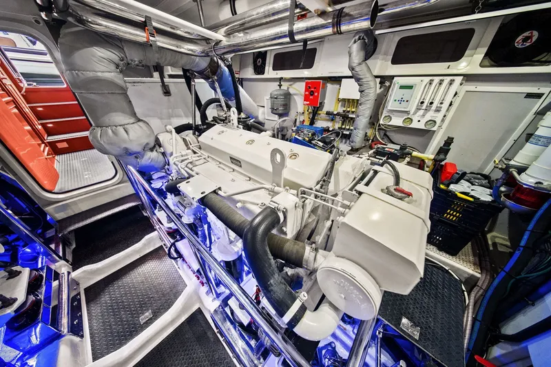 Slide: The Image of Engine room of a 2015 Hampton Endurance yacht, showcasing machinery and control panels. - 60