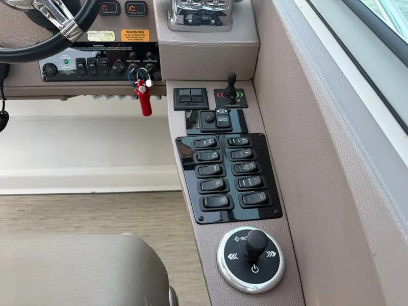 Slide: The Image of The image shows the helm of a 2017 Regal 32 Express boat with various controls. - 15