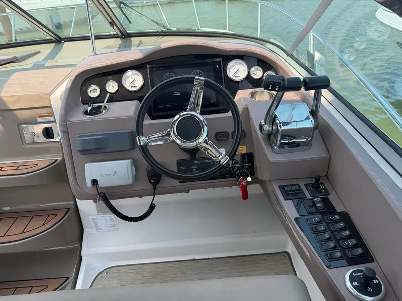 Slide: The Image of The cockpit of the 2017 Regal 32 Express features a modern dashboard with steering wheel and instruments. - 14
