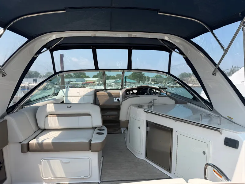 Slide: The Image of The image shows the cockpit of a 2017 Regal 32 Express with beige seating and a helm station. - 5