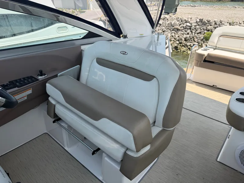 Slide: The Image of The image shows the helm of a 2017 Regal 32 Express with beige and white seating. - 16