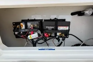 Slide: The Image of 2023 Bayliner 1703 Trophy boat battery compartment with dual batteries and wiring. - 5