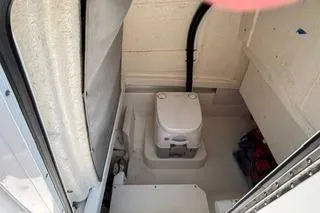 Slide: The Image of 2023 Bayliner 1703 Trophy boat interior with compact marine toilet. - 15