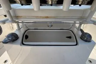 Slide: The Image of 2023 Bayliner 1703 Trophy boat interior with storage compartment and rod holders. - 18