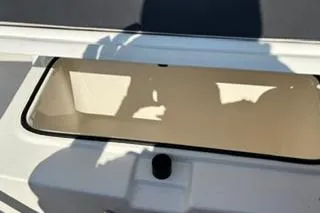 Slide: The Image of 2023 Bayliner 1703 Trophy boat compartment with open lid, showcasing interior space. - 10