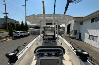 Slide: The Image of 2023 Bayliner 1703 Trophy boat, docked in an industrial area, showcasing its spacious deck. - 4